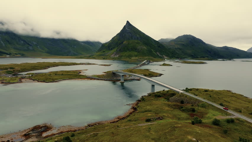 Epic aerial view of a road bridge connecting small islands in beautiful evergreen rocky fjords landscape
