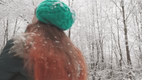 A great way to spend leisure time is the winter landscape forest, which can give true happiness and pleasure. Against backdrop snow-covered forest, a happy woman in video congratulates winter holidays