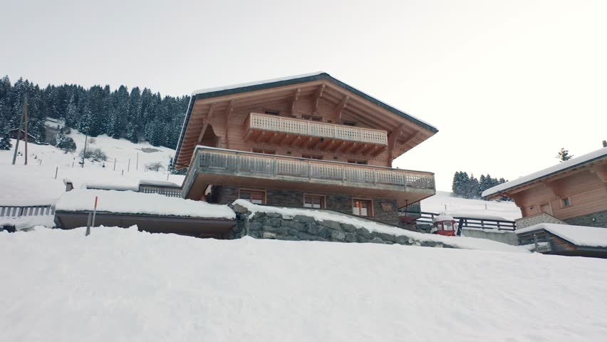 Jib up of luxurious chalet in snow covered landscape