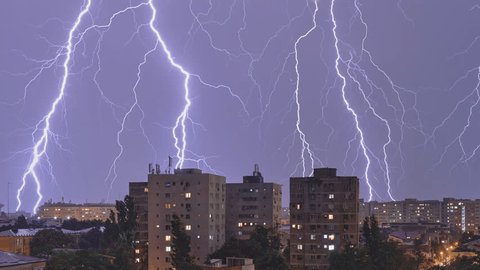 Lightning strikes and thunderstorm over city buildings, at night. Multiple, series, weather phenomena, timelapse. Adlı Stok Video