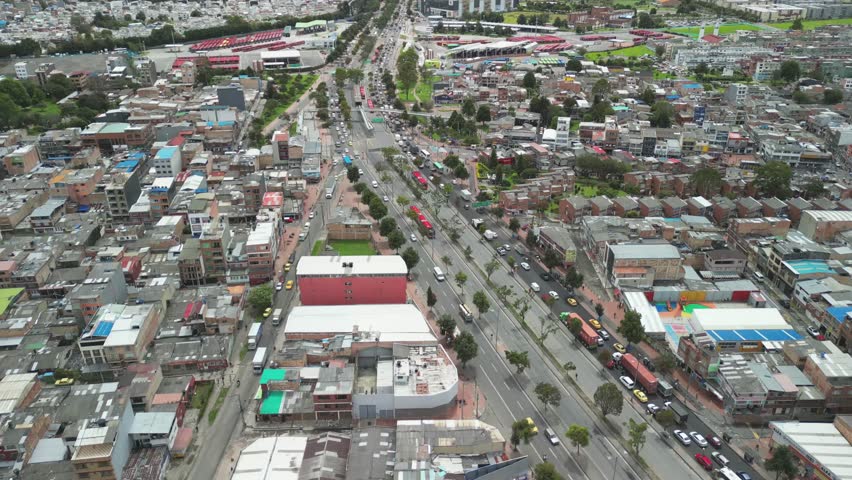 Aerial shot of one of the main roads of Bogotá, Colombia, where traffic and the transportation system called Transmilenio can be seen.
