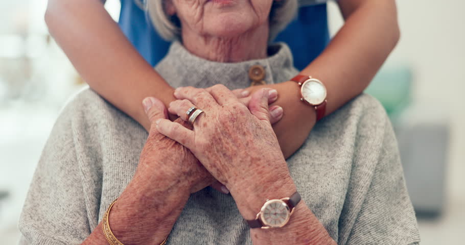 Nurse, holding hands and senior patient hug with caregiver and support in retirement home with empathy. Elderly person, healthcare professional and doctor with kindness, helping and hope in a clinic Royalty-Free Stock Footage #1106715679