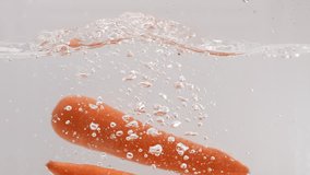 Full high-definition video of carrots falling into water in slow motion - Powered by Shutterstock - Get 15% off with code: PIKWIZARD15