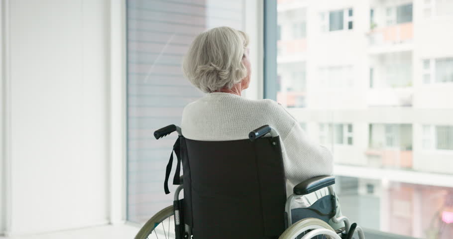Thinking, woman in wheelchair and window in nursing home or person with disability in the hospital with depression or mental health. Depressed, sad and elderly person with .alzheimer or dementia Royalty-Free Stock Footage #1106727421