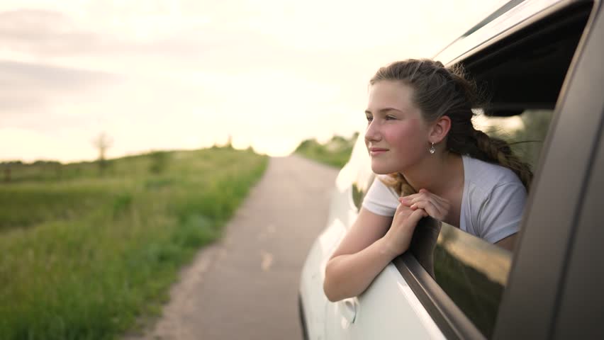 Happy child in car window. Family road trip. Summer adventure on road. Girl child hand from the car window. Family travel enjoyment. Cheerful passenger in car window at sunset. Summer car adventure Royalty-Free Stock Footage #1106730809