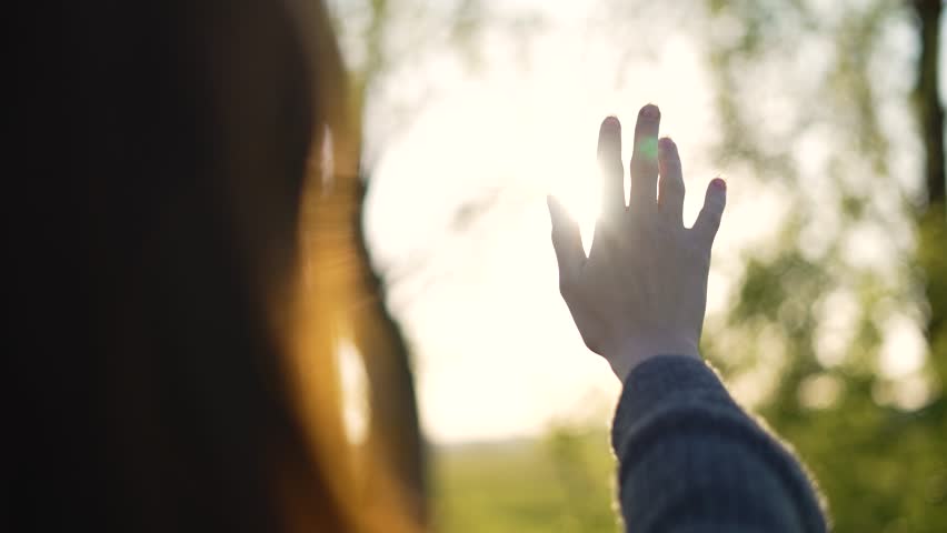 Silhouette of happy dreaming girl pulls her hand to sun.Religion helping hand. Happy girl pulls her hand.Prayer in religion.Silhouette of hand in sun.Happy girl silhouette at sunset.Freedom in nature Royalty-Free Stock Footage #1106730859