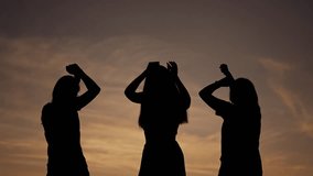 Silhouettes in summer sky. Group of people pray and bask in rays of sunset and sunrise. Raising hands to sky, prayer meeting at dawn in the summer. people unite at sunset and sunrise to worship God - Powered by Shutterstock - Get 15% off with code: PIKWIZARD15