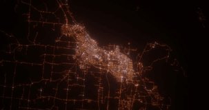 Thunder Bay (Canada) aerial view at night. Top view on modern city with street lights. Camera is zooming out, rotating clockwise. Vertical video. The north is on the left side