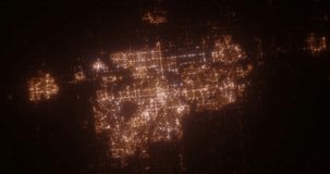Calgary (Canada) aerial view at night. Top view on modern city with street lights. Camera is zooming out, rotating counterclockwise. Vertical video. The north is on the left side