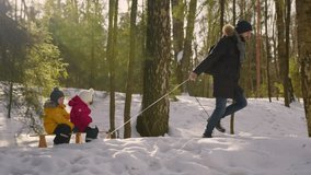 Excited father rides children on sleigh exploring winter forest illuminated by sun - Powered by Shutterstock - Get 15% off with code: PIKWIZARD15