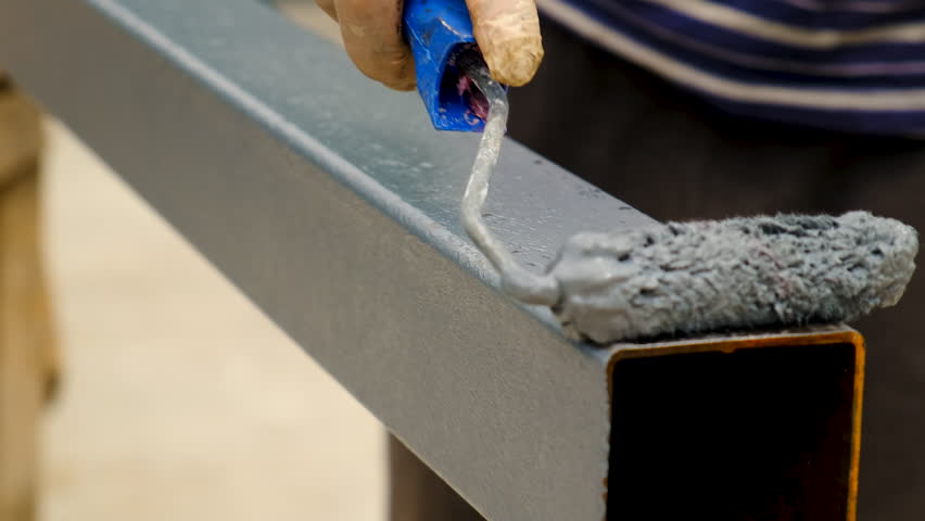 A man paints metal with a roller. Selective focus. Royalty-Free Stock Footage #1106737145