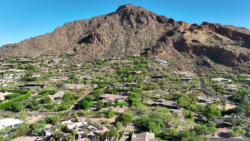 Paradise Valley is an upscale mountainside development in Arizona. Aerial truck shot of mansions built on mountain with amazing view.