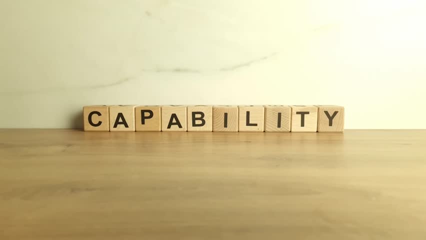 Word capability from wooden blocks. Business concept