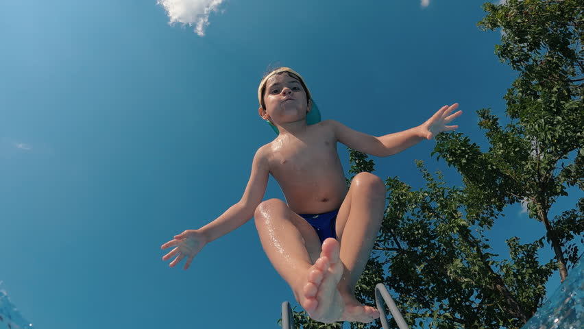 Happy little boy jumping pool blue clear water. Summer swim, underwater leisure