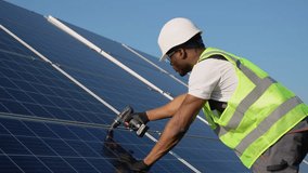African american engineer in safety helmet and uniform at solar power station installing solar panels. Green energy - Powered by Shutterstock - Get 15% off with code: PIKWIZARD15
