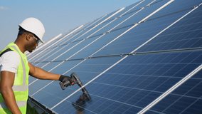 African american engineer in safety helmet and uniform at solar power station installing solar panels. Green energy. - Powered by Shutterstock - Get 15% off with code: PIKWIZARD15