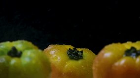Ripe Heirloom Tomatoes Close-Up: Slow Motion Water Spray