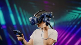 The little girl wearing VR headset in dancing virtual reality. The child in virtual reality play dancing game. Blur background screen. Concept game dance VR headset, active leisure in virtual reality