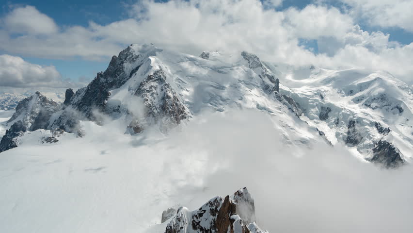 Mont Blanc, Chamonix, France. Time Lapse of Clouds Covering Snow Capped Peaks of French Alps