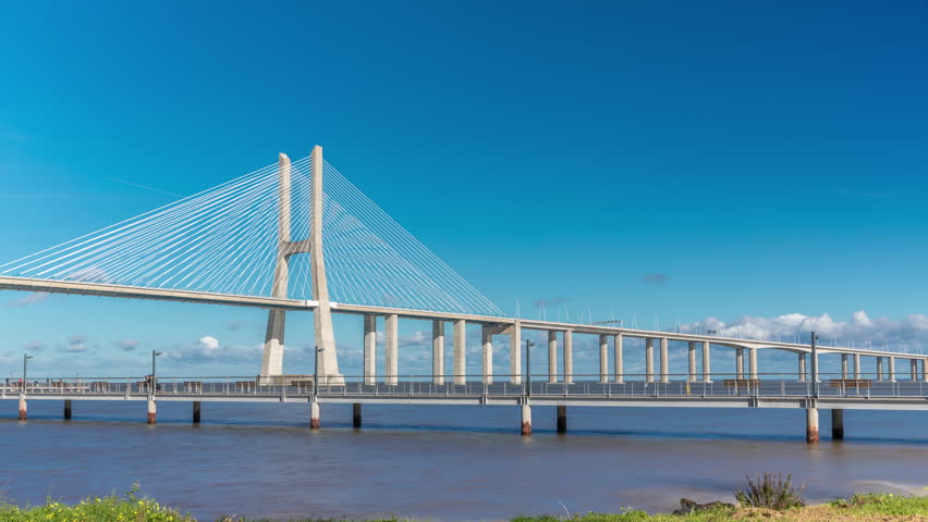 The Vasco da Gama Bridge timelapse hyperlapse. Cable-stayed longest bridge flanked by viaducts and rangeviews that spans the Tagus River in Park of Nations in Lisbon, the capital of Portugal