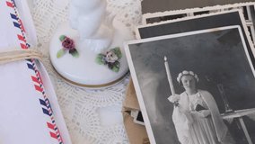 paper envelope with old photographs, bouquet of wild flowers on table wooden table in garden, blurred natural background, concept of genealogy, memory of ancestors, family tree - Powered by Shutterstock - Get 15% off with code: PIKWIZARD15