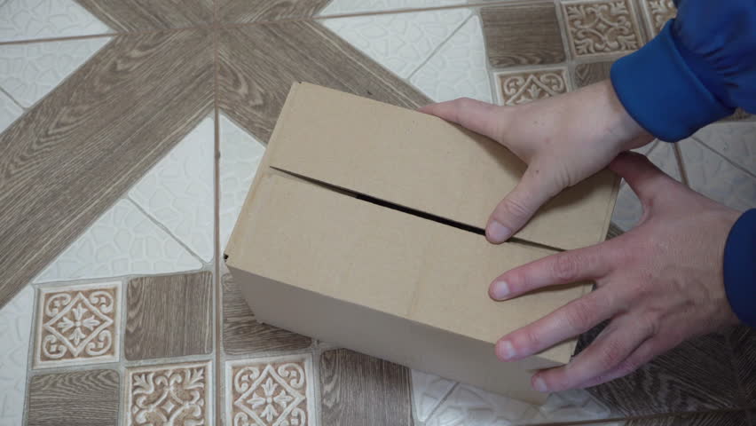 automobile generator in a box,A car mechanic takes a new spare part for a car out of the box