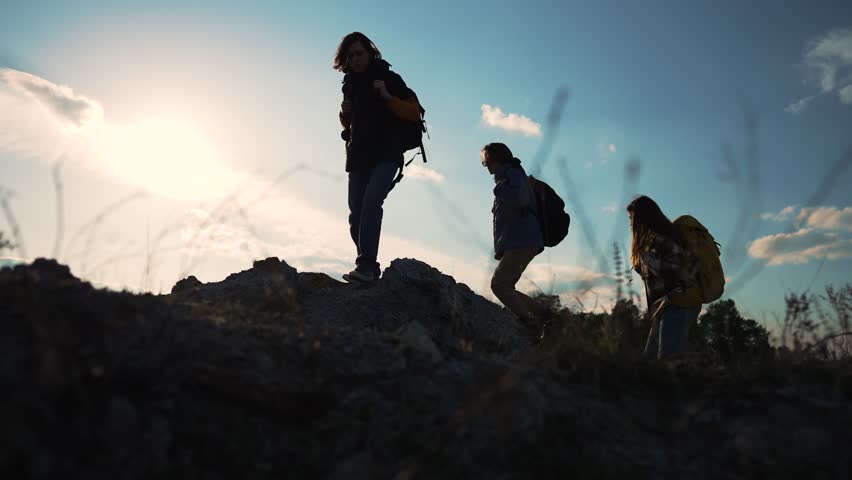 Teamwork. Group of tourists with backpacks hiking in nature in mountains. Trekkers and backpacks at hiking trip in summer. Hiking adventure people travel young group. Active lifestyle travel tourists Royalty-Free Stock Footage #1106771801