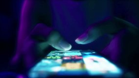 Finger of woman touching scroll page app on mobile phone.In a room with blue and purple neon tones.concept Social media and marketing - Powered by Shutterstock - Get 15% off with code: PIKWIZARD15