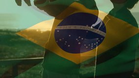Animation of waving brazil flag against caucasian couple holding their baby at the beach. Patriotism, family and fatherhood concept - Powered by Shutterstock - Get 15% off with code: PIKWIZARD15