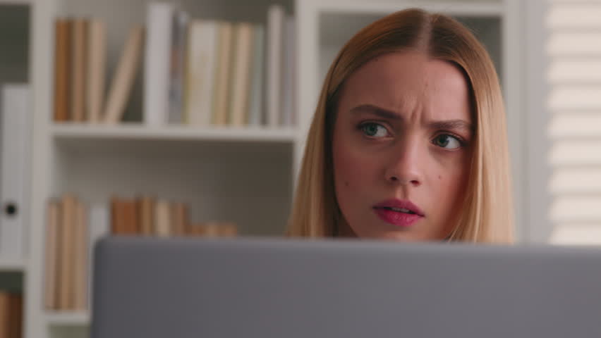 Close up anxiety worried Caucasian businesswoman with computer in office serious girl frown puzzled stressed woman thinking business solution problem thoughtful working online at laptop corporate app Royalty-Free Stock Footage #1106781577
