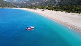 Drone aerial view of sandy seashore bay with turquoise water and boat