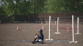 teenage girl fell. girlfriends helped their girlfriend to rise from the ground. teenagers jump over obstacles. Horseback riding. equestrian sport.Full HD video recording