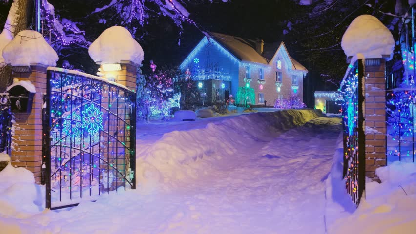 Private house with garlands at night in winter. Christmas concept
