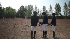 teenagers dressed as riders jump over obstacles. Horseback riding. equestrian sports.teenagers jumping over obstacles.Full HD video recording