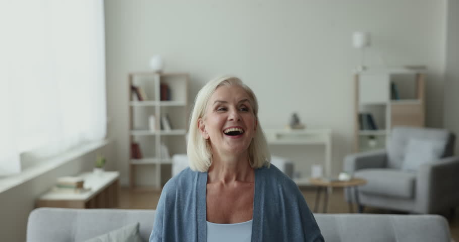 Happy excited senior woman dancing to music in home living room, celebrating achievement, singing song with toothy smile, laughing, enjoying energetic motion, active leisure, success, luck Royalty-Free Stock Footage #1106785671