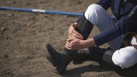 the girl fell. close-up of the injury received by the girl. teenagers jump over obstacles. Horseback riding. equestrian sports.teenager leg injury.Full HD video recording