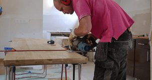 Cinematic shots of woodwork in old house. Wood cutting process in historic renovation. Circular saw usage in interior design project. Circular saw in action during home renovation Cinematic shot