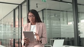 Young busy professional African American business woman company manager sales executive using digital tablet working at desk in office, looking at tab checking web solutions at workplace. - Powered by Shutterstock - Get 15% off with code: PIKWIZARD15