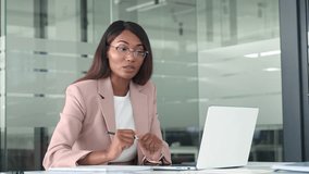 Professional young African American business woman hr manager team leader executive wearing suit, working in office looking at laptop having video conference call hybrid virtual online meeting. - Powered by Shutterstock - Get 15% off with code: PIKWIZARD15