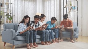 Asian Teenagers Playing Video Games On Smart Phone At Home.
