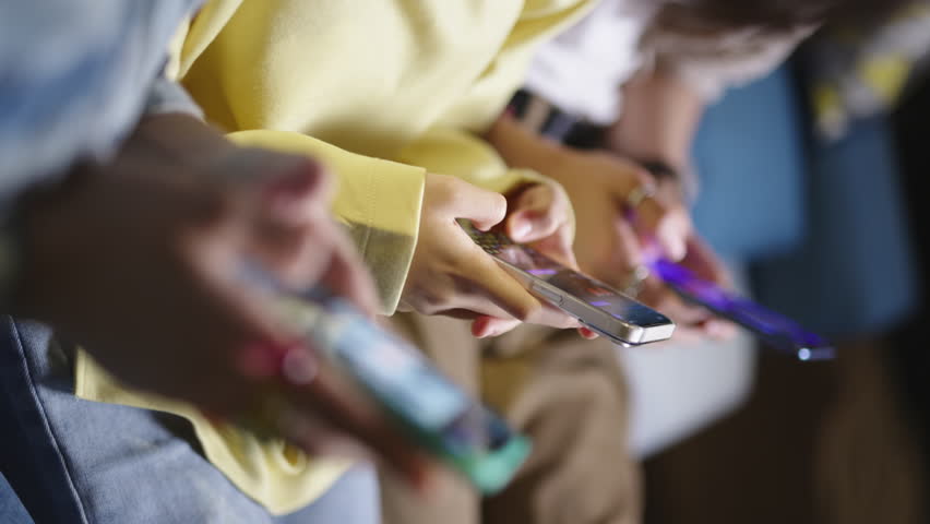 Hands of diverse people holding smartphone ignoring friends chatting in messenger. Smartphone addicted people internet overuse problem modern wireless tech usage. Gen Z people addicted to social media - Powered by Shutterstock - Get 15% off with code: PIKWIZARD15