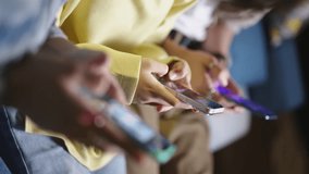 Hands of diverse people holding smartphone ignoring friends chatting in messenger. Smartphone addicted people internet overuse problem modern wireless tech usage. Gen Z people addicted to social media - Powered by Shutterstock - Get 15% off with code: PIKWIZARD15