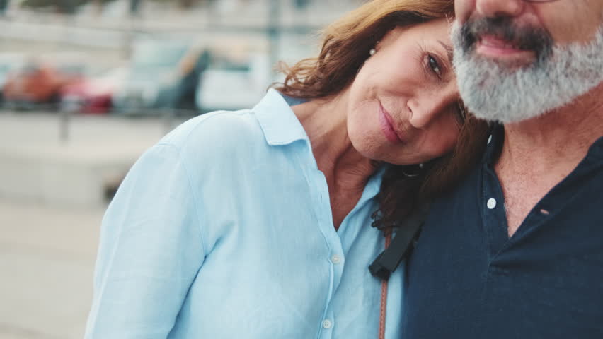 Close-up of beautiful older woman resting her head on her boyfriend