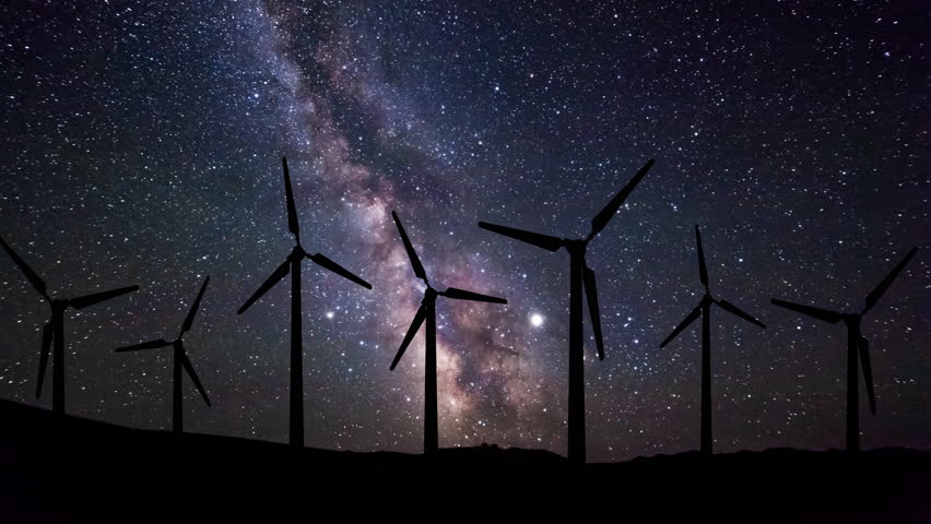Wind turbines at night under the starry sky. Timelapse.
