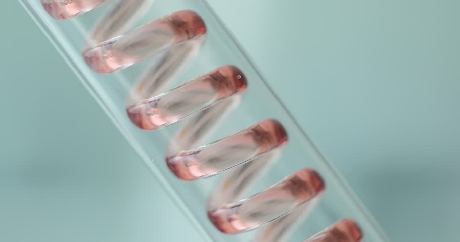 Red liquid flows through spiral tube in laboratory equipment