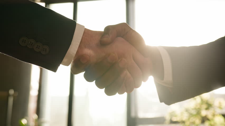 Close up male hands multiethnic Caucasian and African business people men diverse businessmen shaking successful corporate partnership deal union agreement hire handshake in office in sunny sun beams Royalty-Free Stock Footage #1106808557