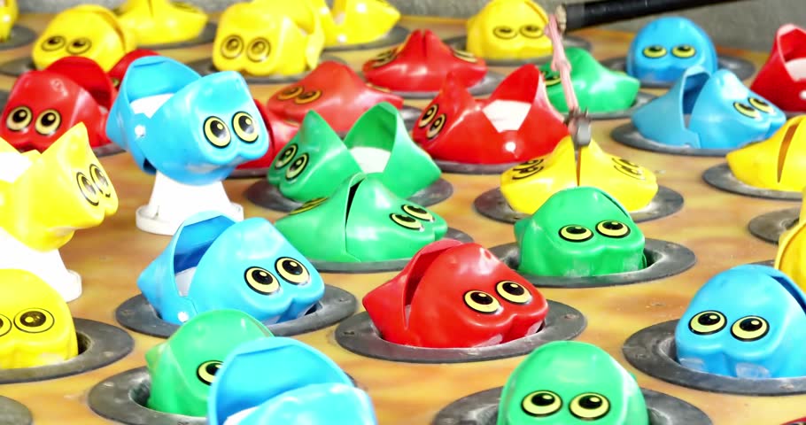 Fishing whack a mole or fried frogs carnival game on the midway of a county fair. Giant Frog Fish Royalty-Free Stock Footage #1106815671