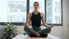 Video of sporty woman doing yoga exercises at home