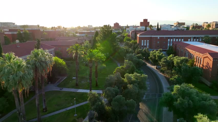 East University Boulevard at University of Arizona. Aerial establishing shot of Old Main building and scenic landscaping at college campus in Tucson, AZ.