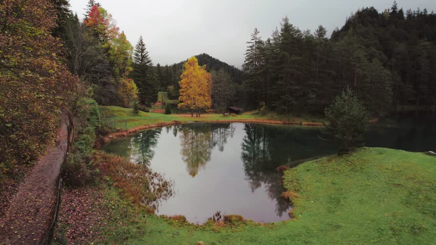 Moody Aerial video of Fernsteinsee lake in Austria in autumn season 